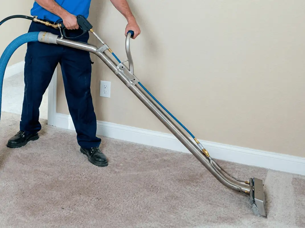 Professional operating a liquid removal machine on a carpeted floor in Pueblo, CO